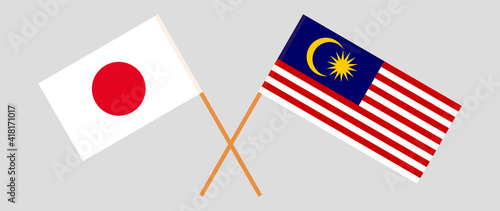 Crossed flags of Japan and Malaysia. Official colors. Correct proportion