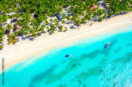 Saona, Dominican Republic. Vacation background. Aerial drone view of beautiful caribbean tropical island beach with palms and boats