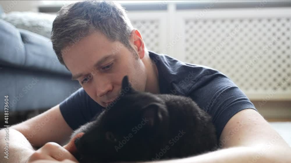 Man playing with his Schipperke dog. Man playing with his Schipperke dog.