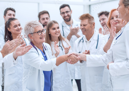happy medical colleagues congratulating each other on their success.