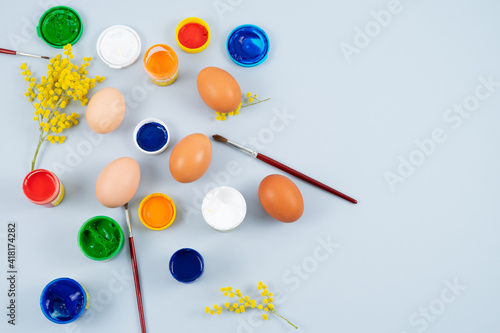 Eggs and paints. Easter eggs decoration process. Copy space. Top view.