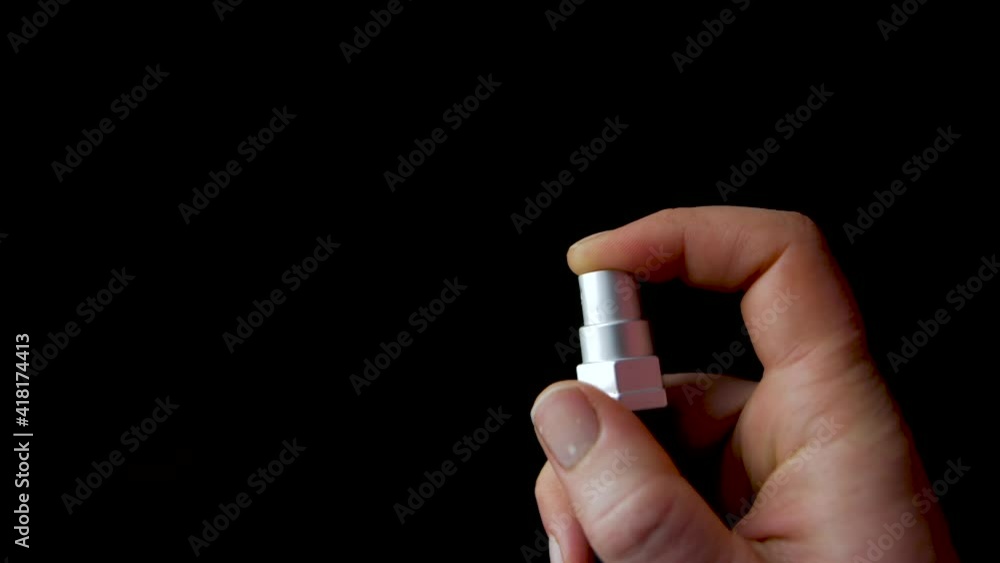 Close-up hand of woman using disinfectant spray against covid-19 virus isolated on black background.slow motion video.woman using spray footage. Close-up hand of woman using disinfectant spray against covid-19 virus isolated on black background.slow motion video.woman using spray footage.