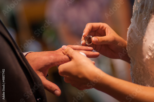 the bride and groom exchange rings. High quality photo
