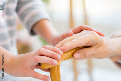 Helping hands of youngster for old woman