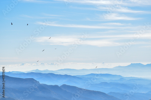 Landscape of foggy mountains and birds