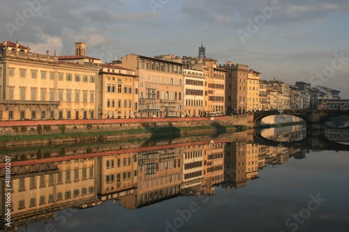 Florence, Italy. Buildings under morning sun reflecting in the Arno river. 