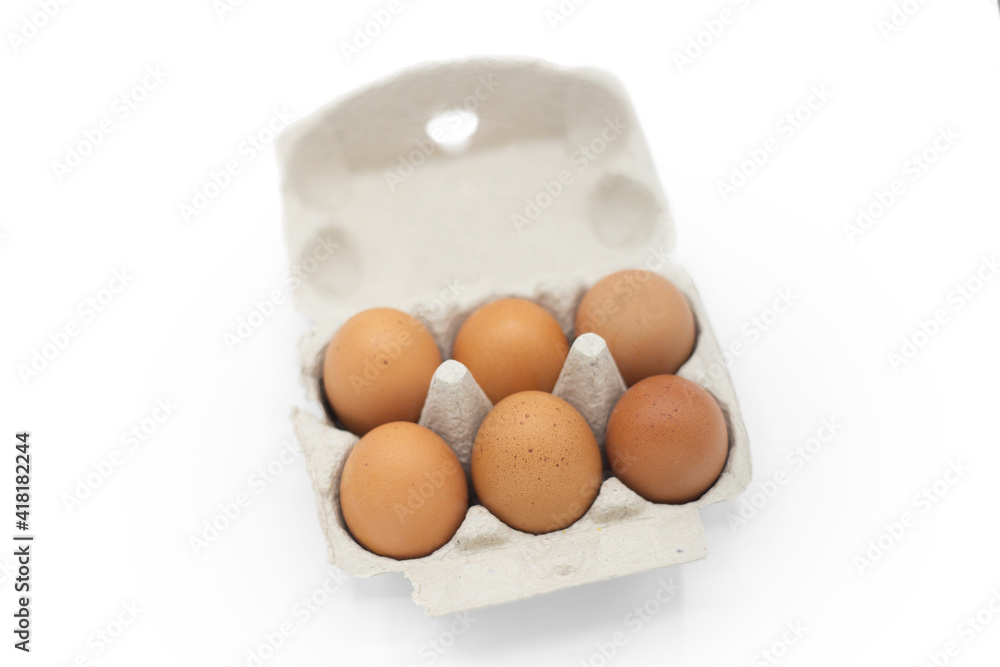 Close up of an open recyclable egg carton with six eggs inside. Product, ecological healthy food and farm Concept
