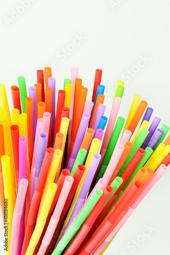 Multicolored cocktail straws on a white background. Colorful accessory and decoration for a cocktail and drinks party.