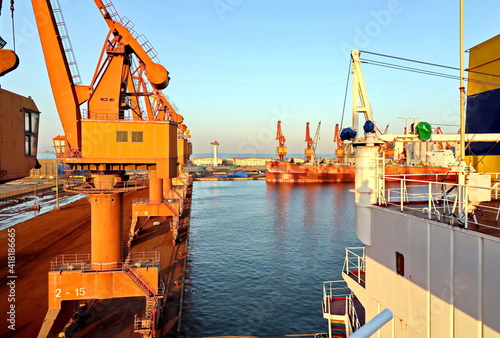 Cargo terminal for unloading bulk cargoes by shore cranes. Views of the pier and vessels under loading operation. Jinzhou, China, September,2020. photo