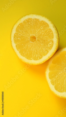 Half of the cut lemon isolated on yellow