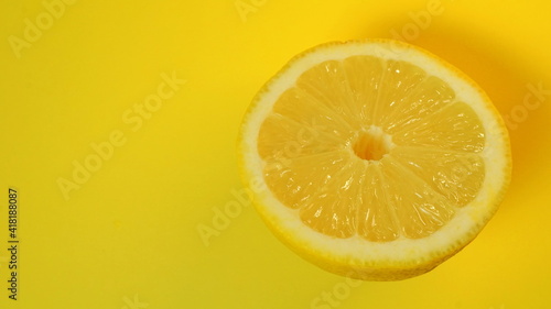 Half of the cut lemon isolated on yellow