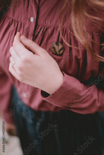 wooden brooch on the shirt. Decoration made from natural materials © Natalia