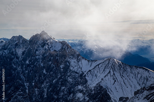 clouds over snow covered mountains