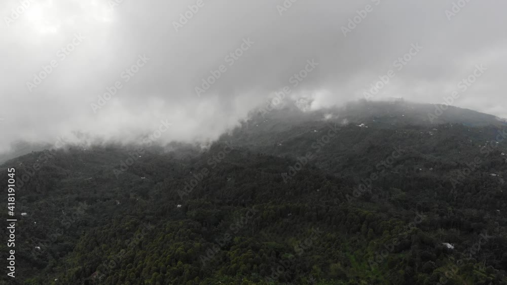 Mystical forest in the fog. Aerial view of over tropical rainforest in mountains with white fog Mystical forest in the fog. Aerial view of over tropical rainforest in mountains with white fog