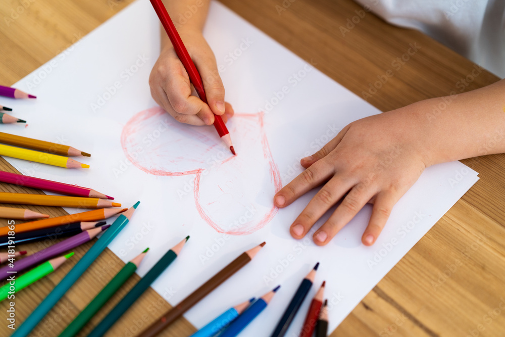 Little girl draws a red heart Little girl draws a red heart