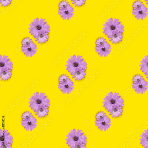Seamless pattern. Pink flowers on the yellow background.