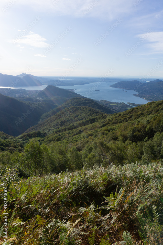 Lake maggiore and lake mergozzo seen from the mountains of val d'ossola during a summer day, near the town of Mergozzo, italy - September 2020. Lake maggiore and lake mergozzo seen from the mountains of val d'ossola during a summer day, near the town of Mergozzo, italy - September 2020.