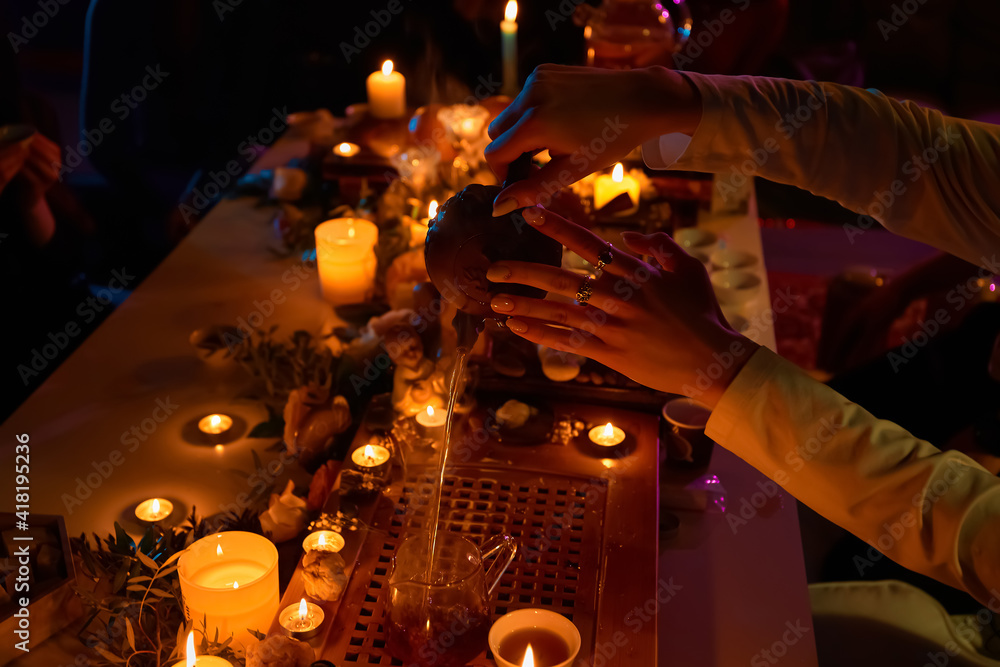 Tea ceremony, candles roses and stones, spa relaxation. Pours boiling