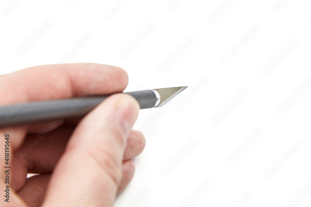 Craft knife in hand isolated on white background. Paper knife cutter Craft knife in hand isolated on white background. Paper knife cutter