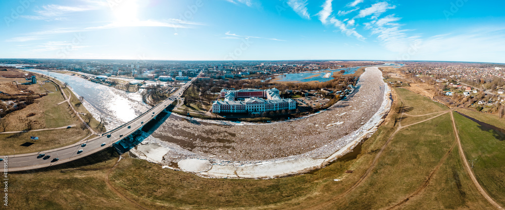 Panoramic view over city Jelgava (Mitava palace), Lielupe river and ''Latvia University of Agriculture'' during sunny spring day with ice pieces in river