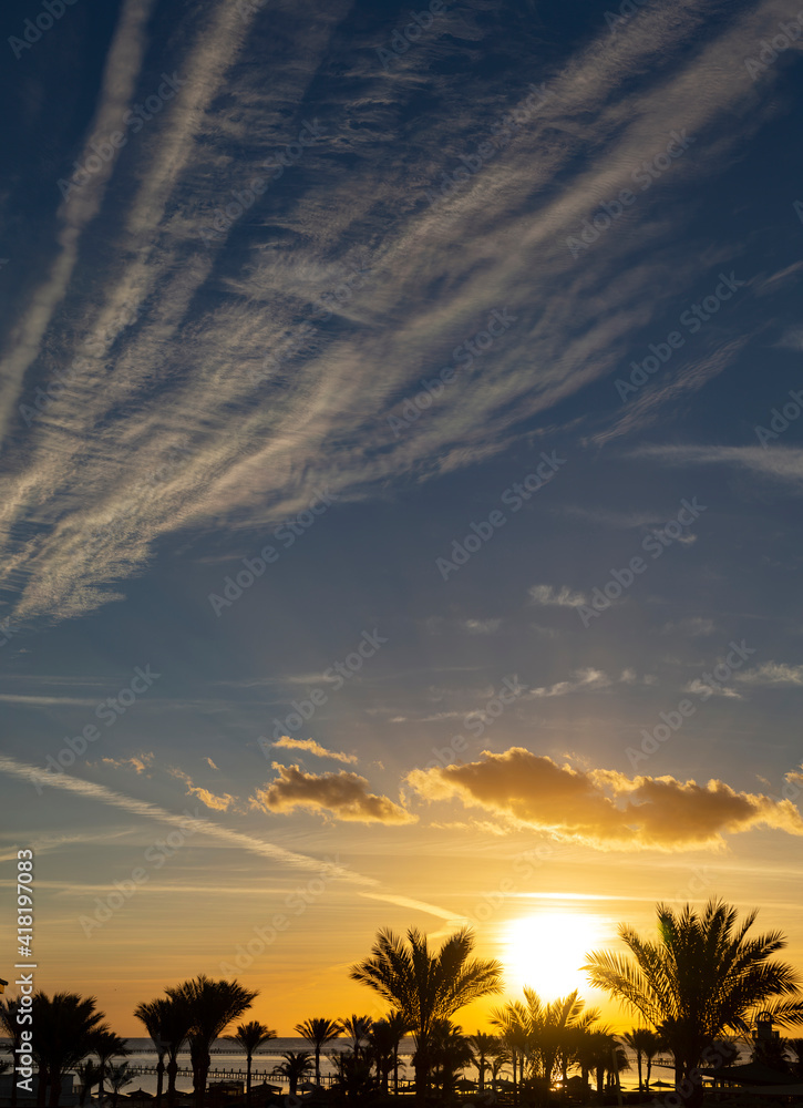Fototapeta premium Sunrise on the sea coast. The movement of the sun and clouds across the sky.