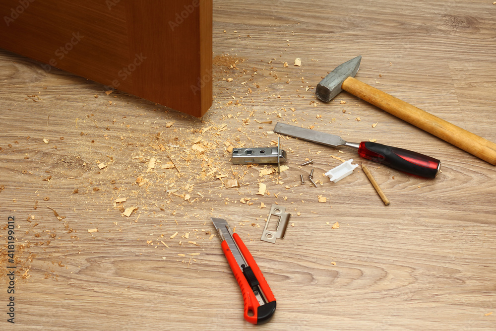 Shavings on floor from door latch installing. Wood sawdust from hole
