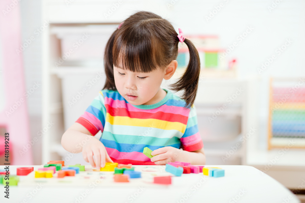young girl learning letter blocks for homeschooling young girl learning letter blocks for homeschooling
