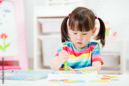 young girl playing creative toy blocks for homeschooling