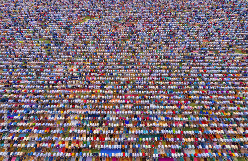 Aerial view of a vast crowd of people worshipping at Gore Shahid park in front of Eid Gah Minar religious site in Dinajpur, Rangpur, Bangladesh. photo
