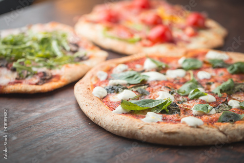 Home made pizza on dark wooden background