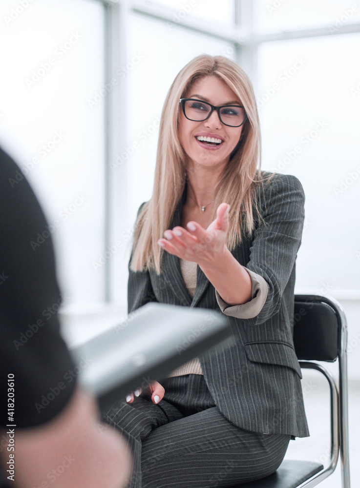 business woman answering questions during an interview. business woman answering questions during an interview.