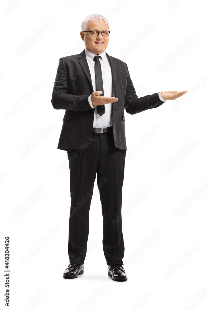 Full length portrait of a middle aged businessman showing with hands Full length portrait of a middle aged businessman showing with hands