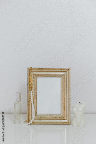 Feminine Mockup vintage gold frame and candle. Wedding still life. Cozy Aesthetic Background. Parisian chic