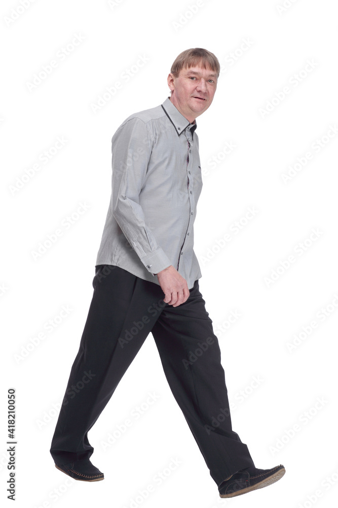 happy mature man in white shirt striding forward. happy mature man in white shirt striding forward.