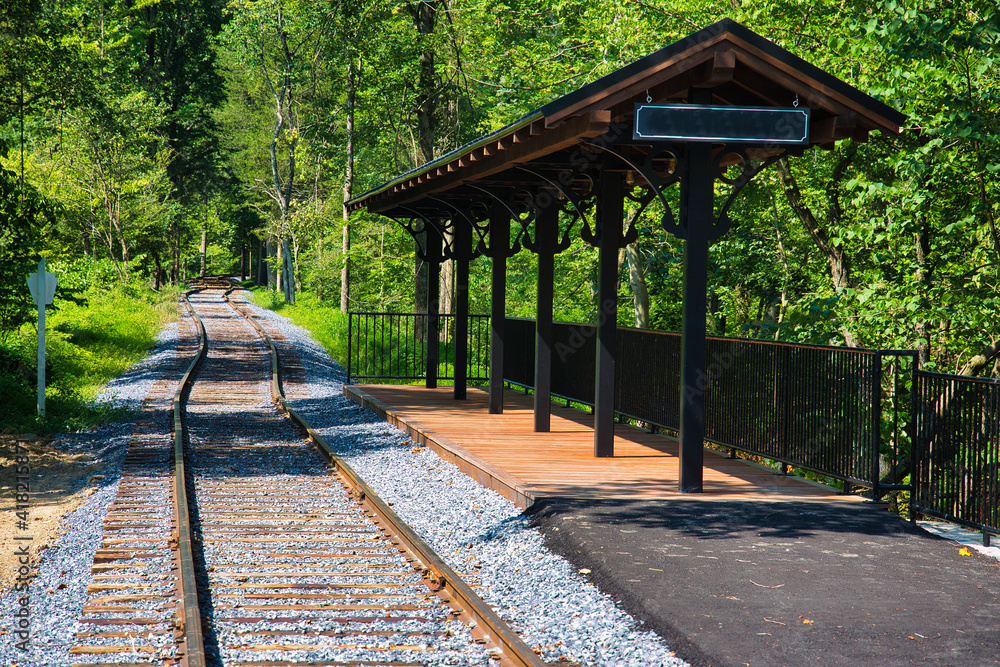 Obraz premium A Small Train Station Waiting for Passengers and a Train