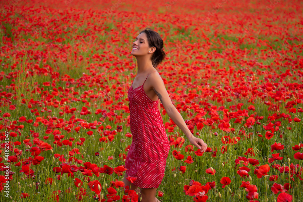Carefree woman in poppy flower field. Wildflowers botanical plant female. Anzac day. Carefree woman in poppy flower field. Wildflowers botanical plant female. Anzac day.