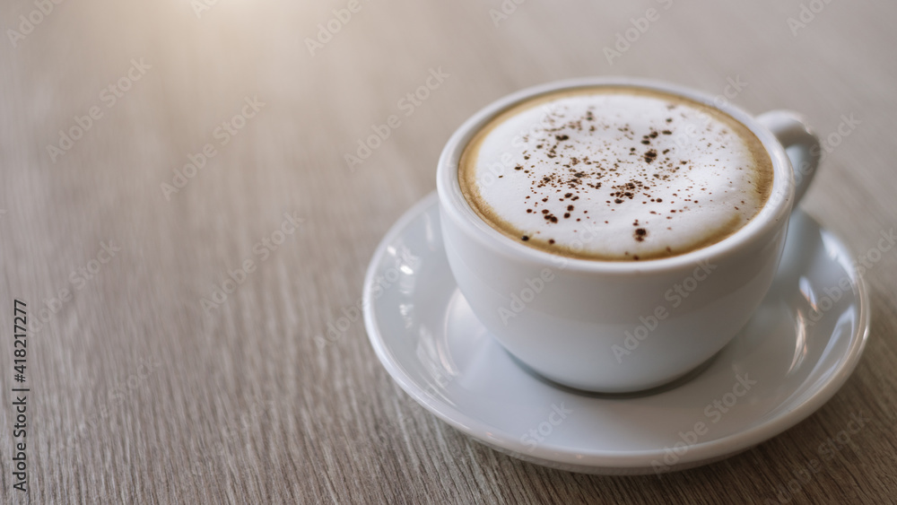 cup of cappuccino on wooden table. cup of cappuccino on wooden table.