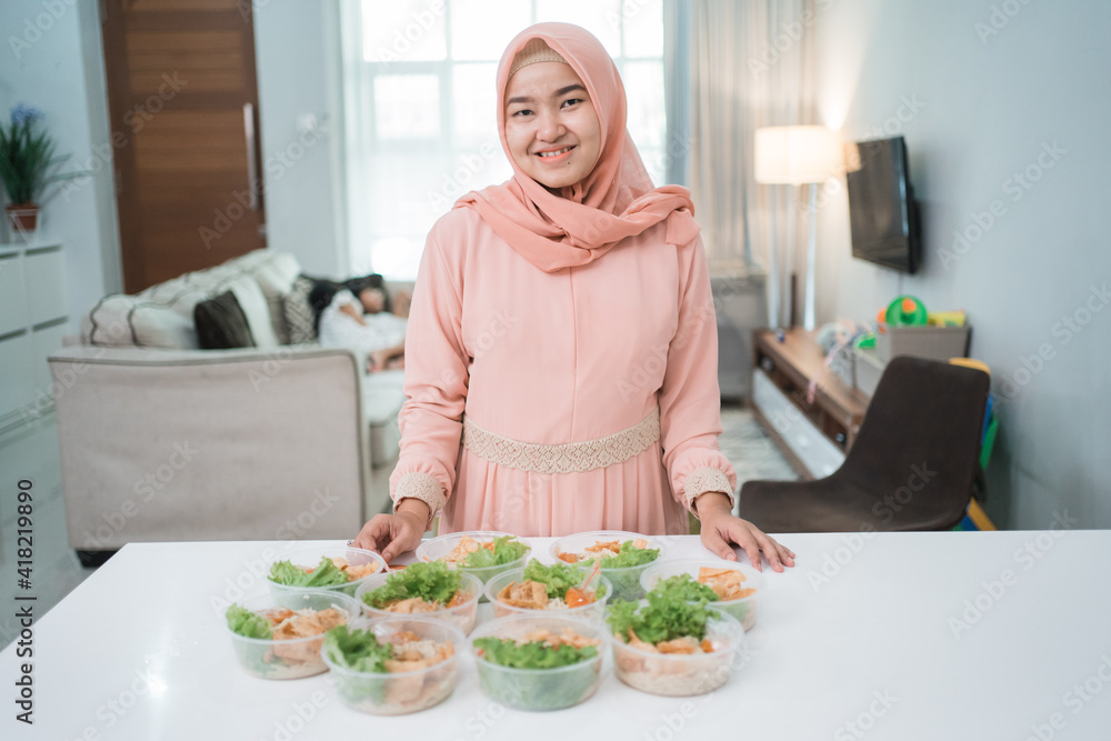 portrait of asian muslim woman food seller preparing her product at home kitchen portrait of asian muslim woman food seller preparing her product at home kitchen
