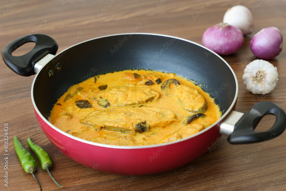 Kerala fish curry coconut milk gravy , cooking spicy Goan fish curry