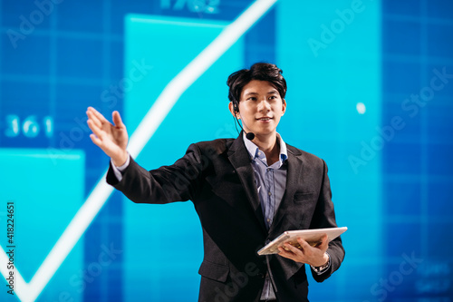 Canvas Print Asian Businessman Stands on Stage for Business Presentation