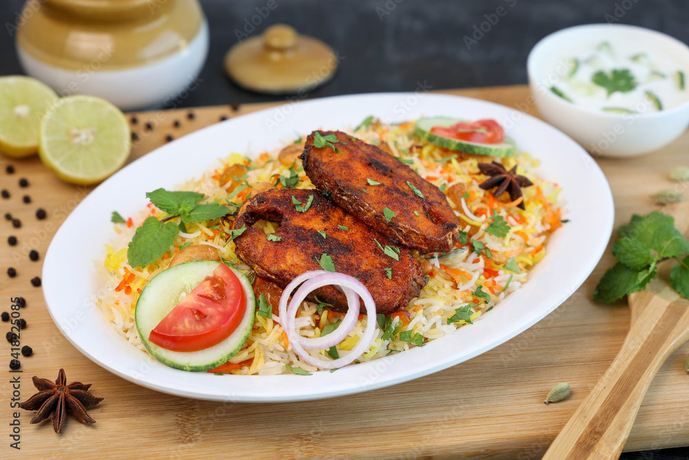 Fish biryani , Spicy and delicious Malabar biryani or Hyderabadi biryani, Dum Biriyani, pulao Kerala India Sri Lanka . basmati rice, herbs, raitha for Ramadan Kareem, Eid Fish biryani , Spicy and delicious Malabar biryani or Hyderabadi biryani, Dum Biriyani, pulao Kerala India Sri Lanka . basmati rice, herbs, raitha for Ramadan Kareem, Eid