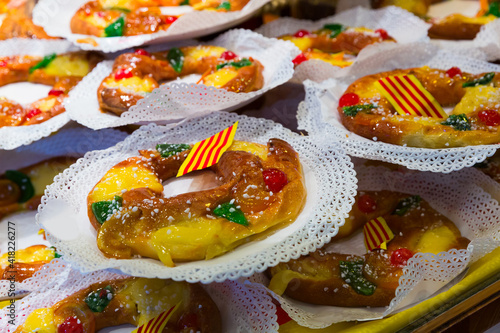 Delicious tortell (Coca de reyes) - ring shaped brioche decorated with sugared fruit and traditionally eaten in Catalonia during celebration of Epiphany  photo