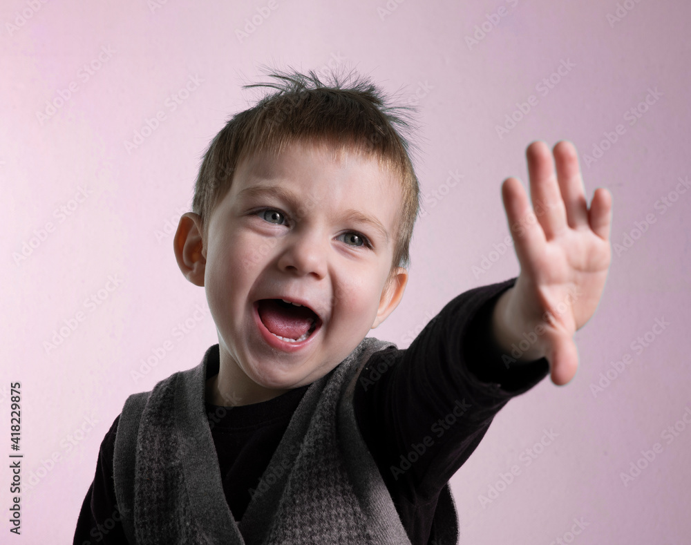 Crying Boy makes a protective gesture with his left hand in fear Crying Boy makes a protective gesture with his left hand in fear