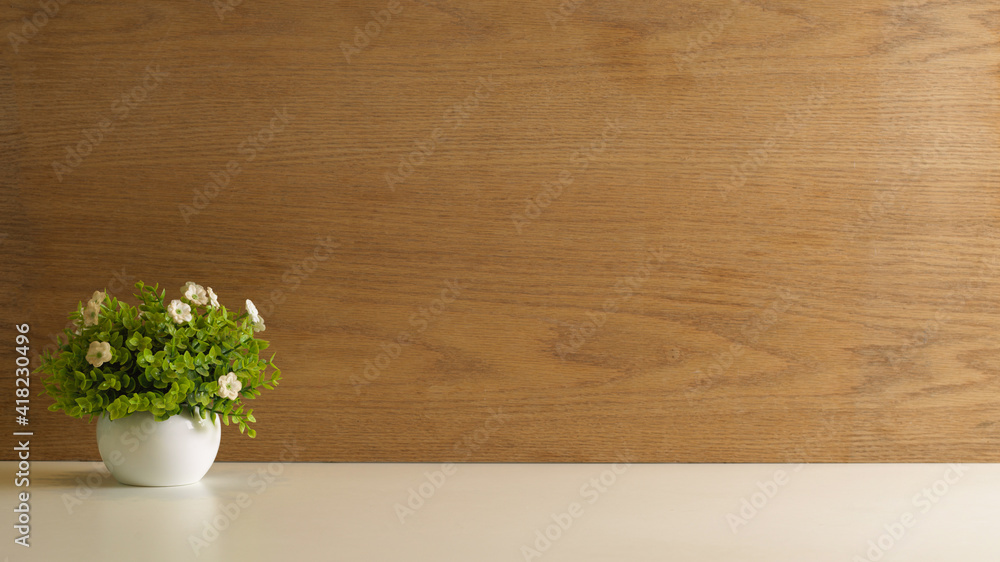 Mock up scene, plant pot on white table with copy space and wooden wall background Mock up scene, plant pot on white table with copy space and wooden wall background