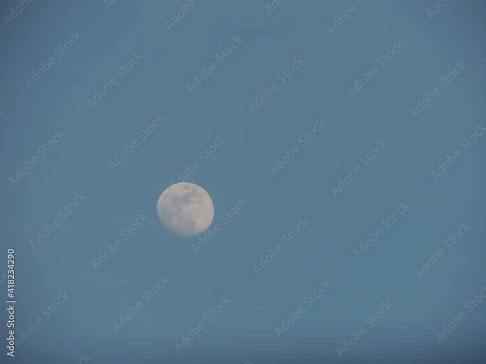 sunset late afternoon Quater Moon in a blue sky sunset late afternoon Quater Moon in a blue sky