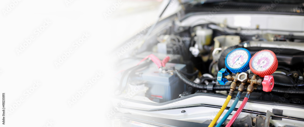 Fototapeta premium Car air conditioner check service, leak detection, fill refrigerant.Device and meter liquid cooling in the car by specialist technicians.