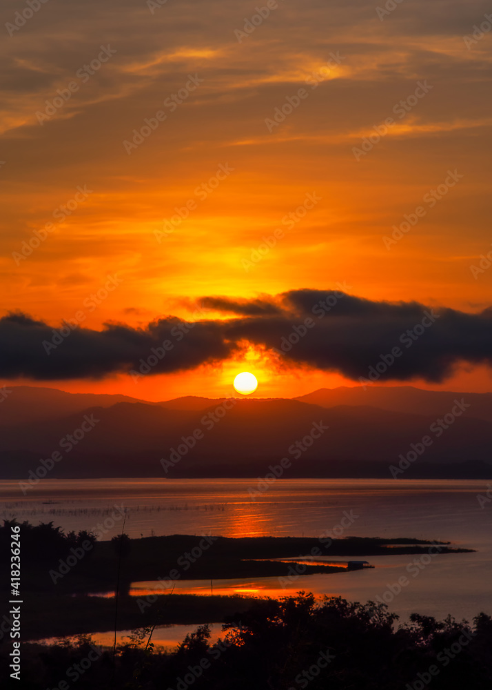 Beautiful scenery with sun and clouds during sunrise with mountain view as background.