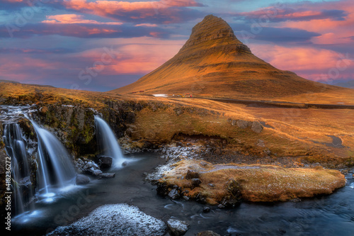 Landscape on Kirkjufellsfoss waterfall and Kirkjufell mountain, Iceland in Europe before sunset time.