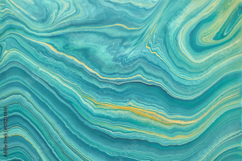 Abstract fluid art background blue and golden glitter colors. Liquid marble.