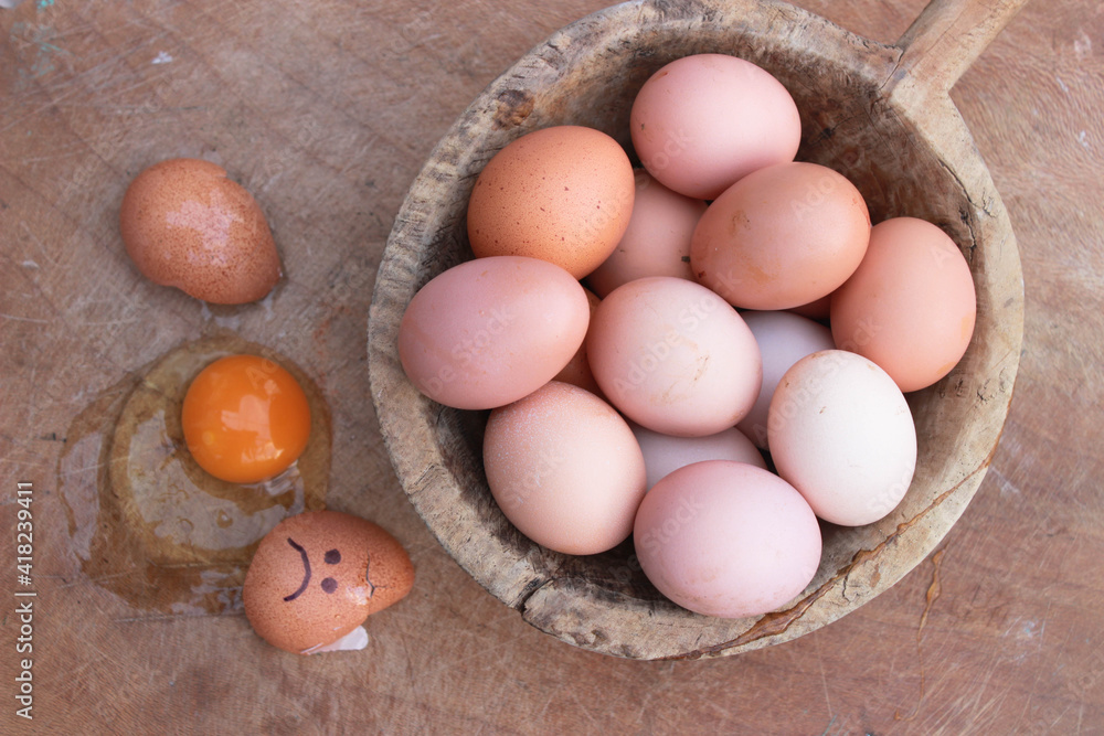 eggs are funny with the face. Concept: the pain broke cracked. Photo for your design on a wooden background. Copy space for your text. eggs are funny with the face. Concept: the pain broke cracked. Photo for your design on a wooden background. Copy space for your text.